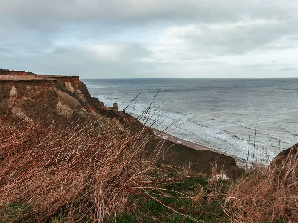 Looking along and down the rugged cliffside, to the sea below, when walking between Cromer and Mundesley.