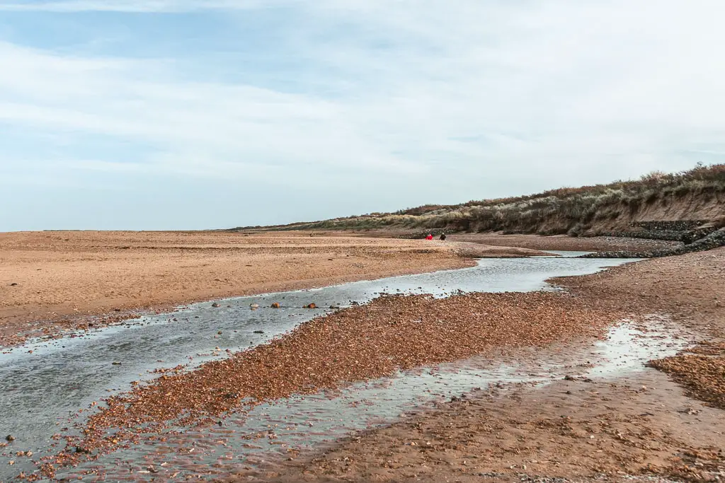 Streams of water running across the sandy beach, when walking from Hunstanton to Burnham Overy Staithe.