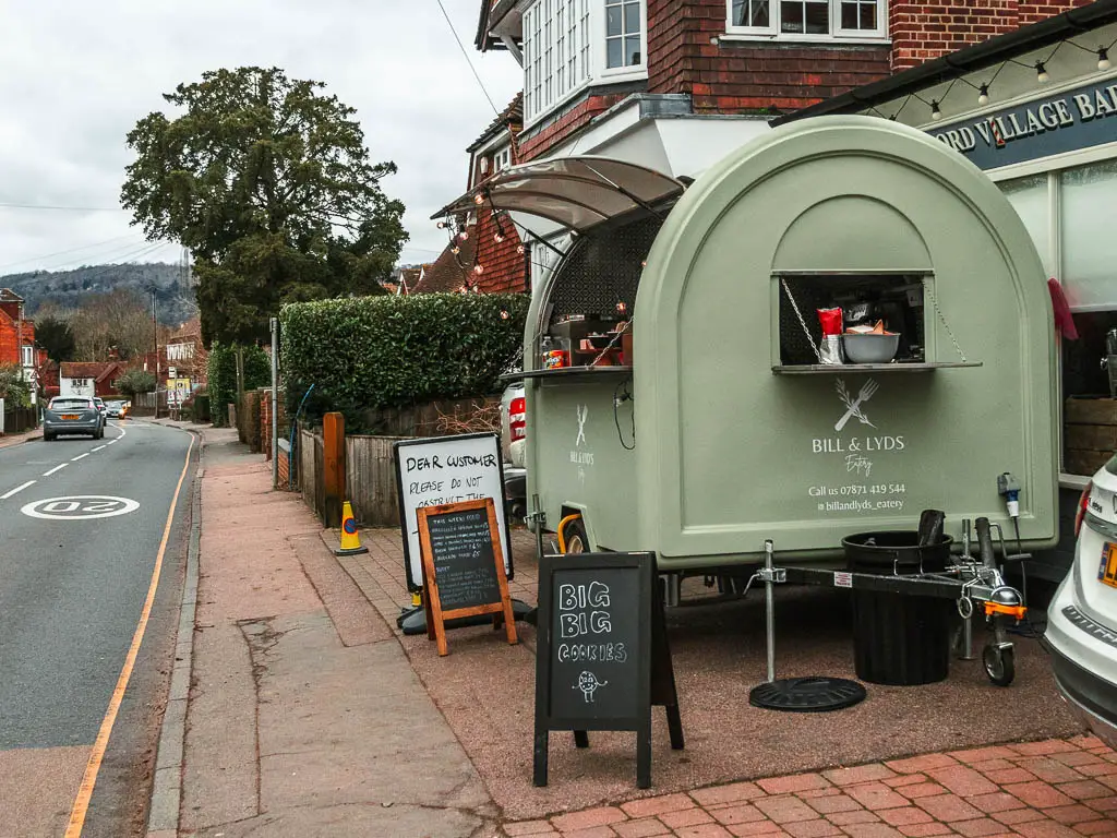 A light green pop up food stall next to the road in Otford.