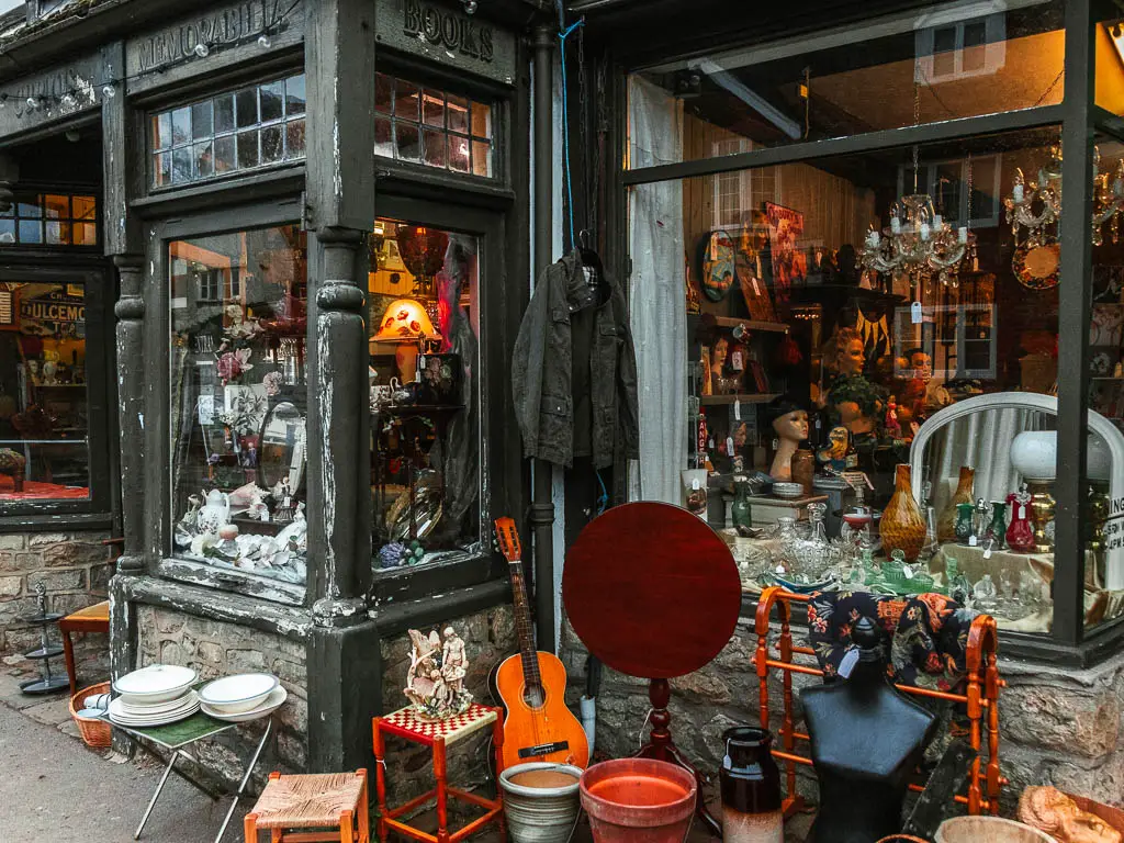 An antique shopfront with lots of antiques and trinkets outside and in the shop window at the end of the walk in Otford. 