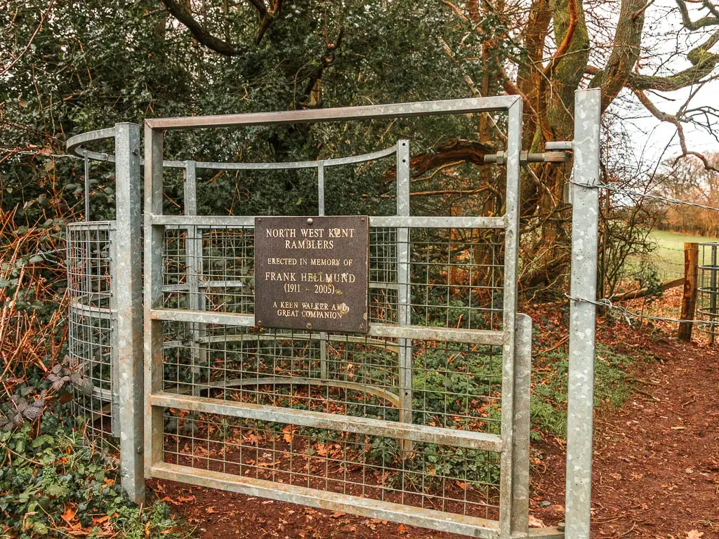 A metal gate with a memorial plaque on it..