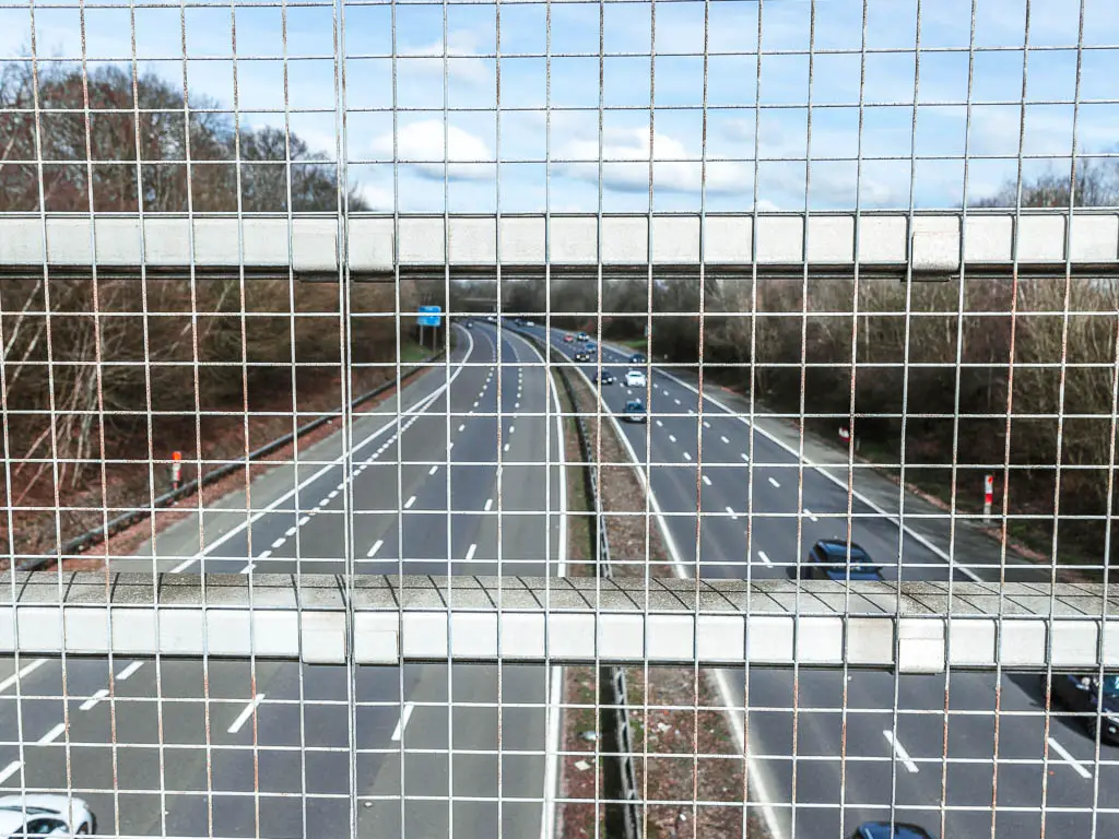 Looking through metal railings to the motorway below.