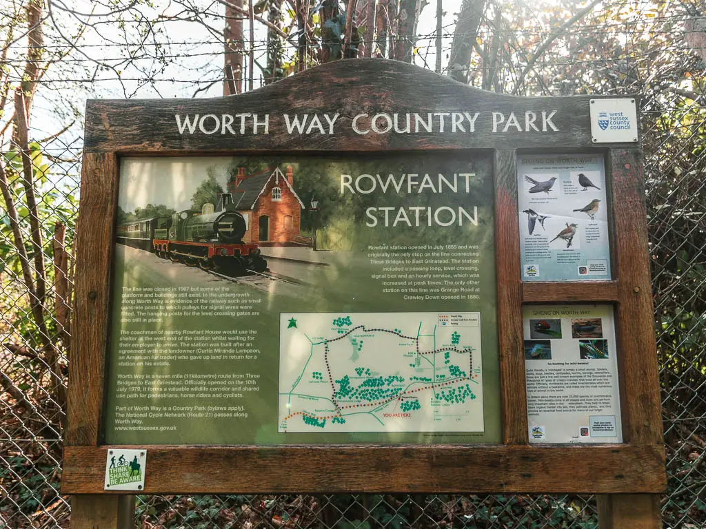 An information board saying the Worth Way country park. The board gives information about Rowfant Station.