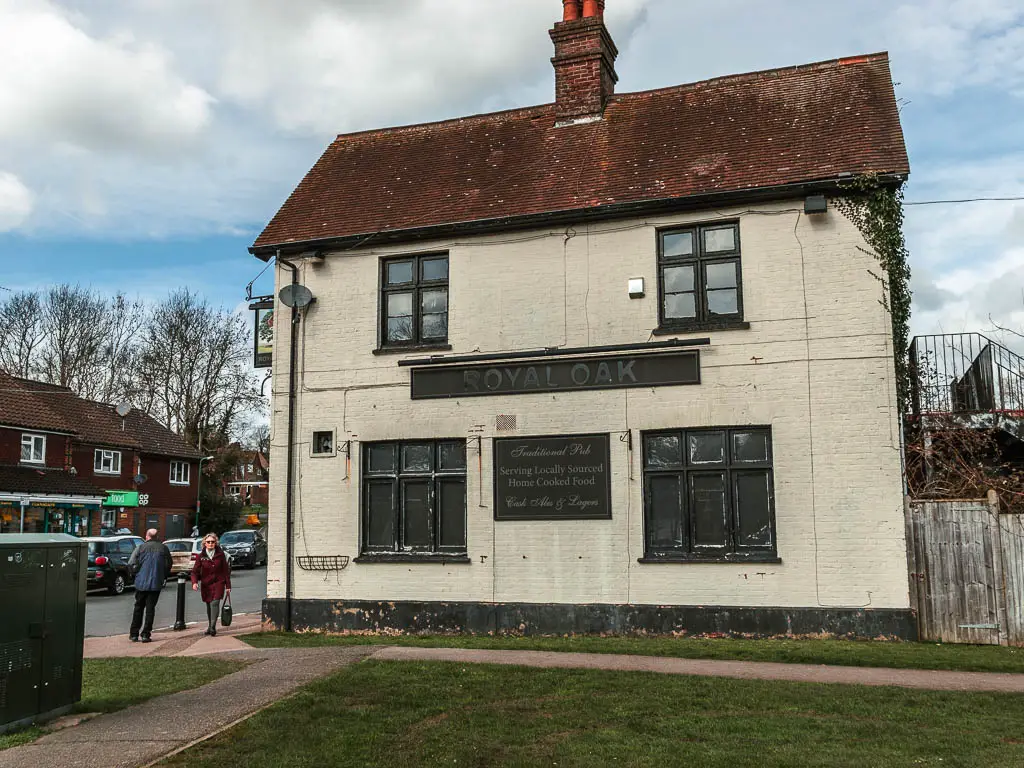 The old abandoned Royal Oak pub building, with black closed shutters.