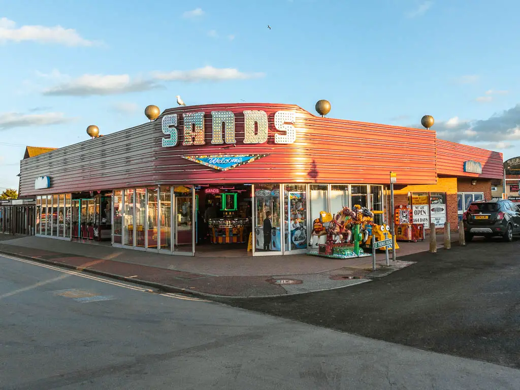 A colourful arcade on a street corner.