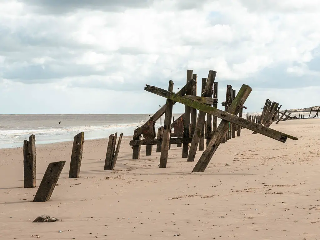 Wooden structures spread across the long pale sandy beach.