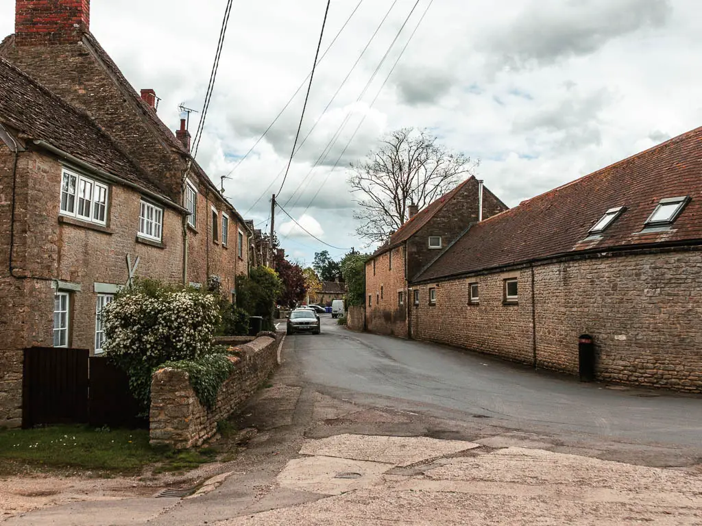 Looking along a road lined with stone buildings.