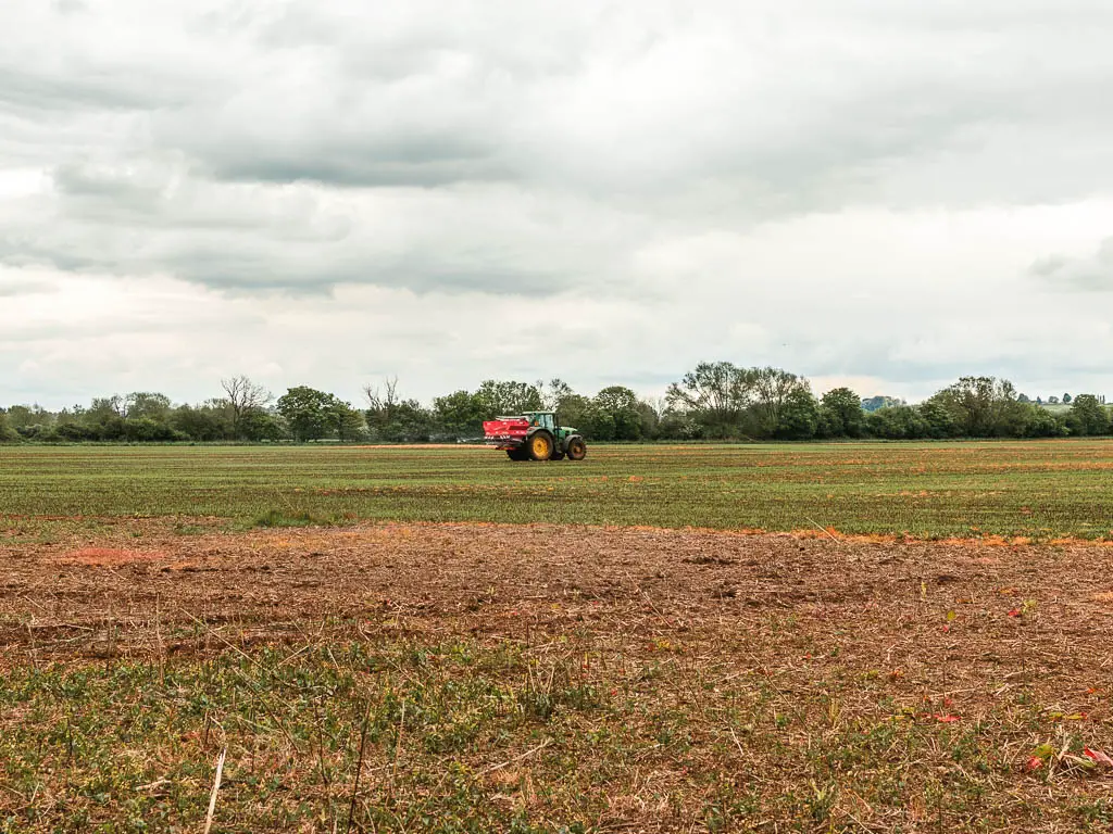 A large field with a tracker in the middle, on the walk between Cricklade and Lechlade.