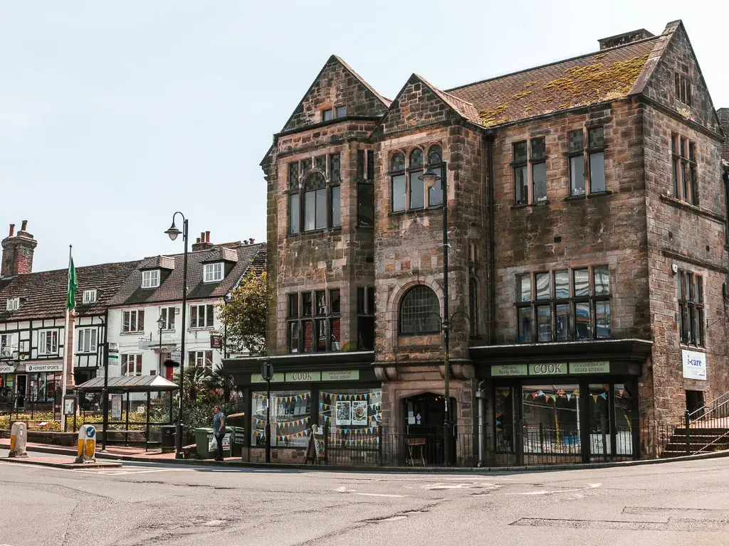 A very large old brown brick building on the street in East Grinstead.