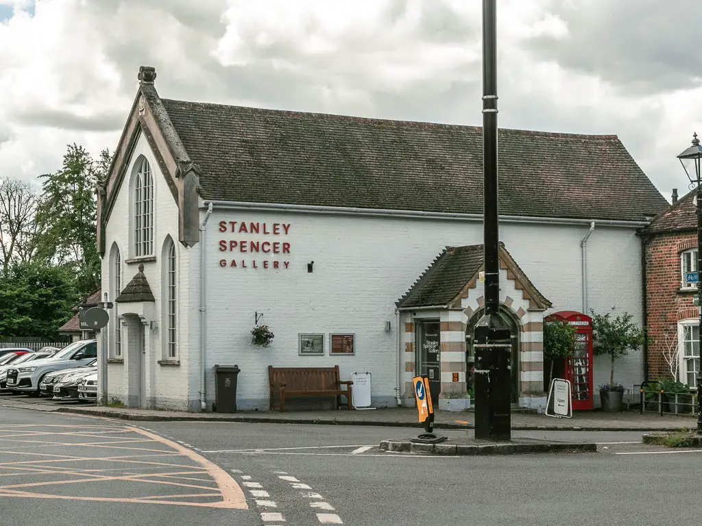 Looking across the road to a big white walled buildings with 'Stanley Spencer gallery' in red writing on it.