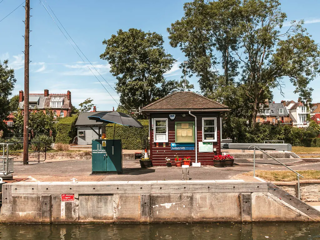 Looking across the lock to a small hut lock shed. 