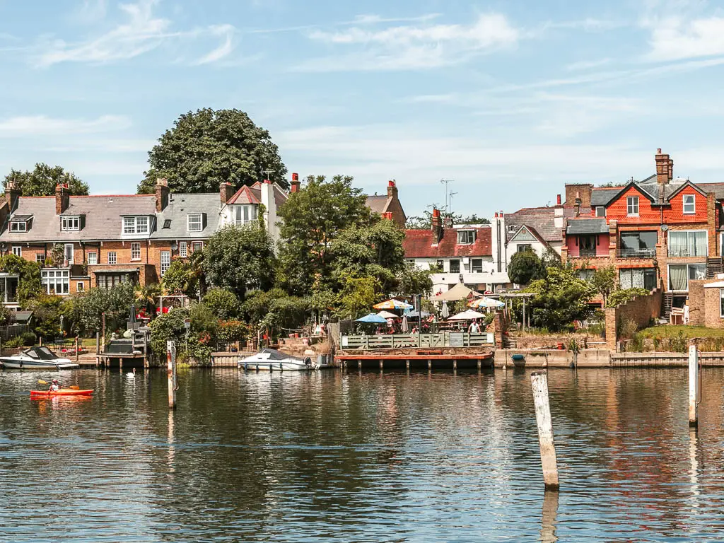 Looking across the river to a variety of houses and trees partway through the walk from Shepperton to Hampton Court.