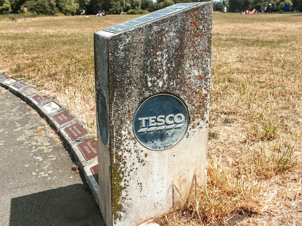 A stone block with Tesco plaque on it.