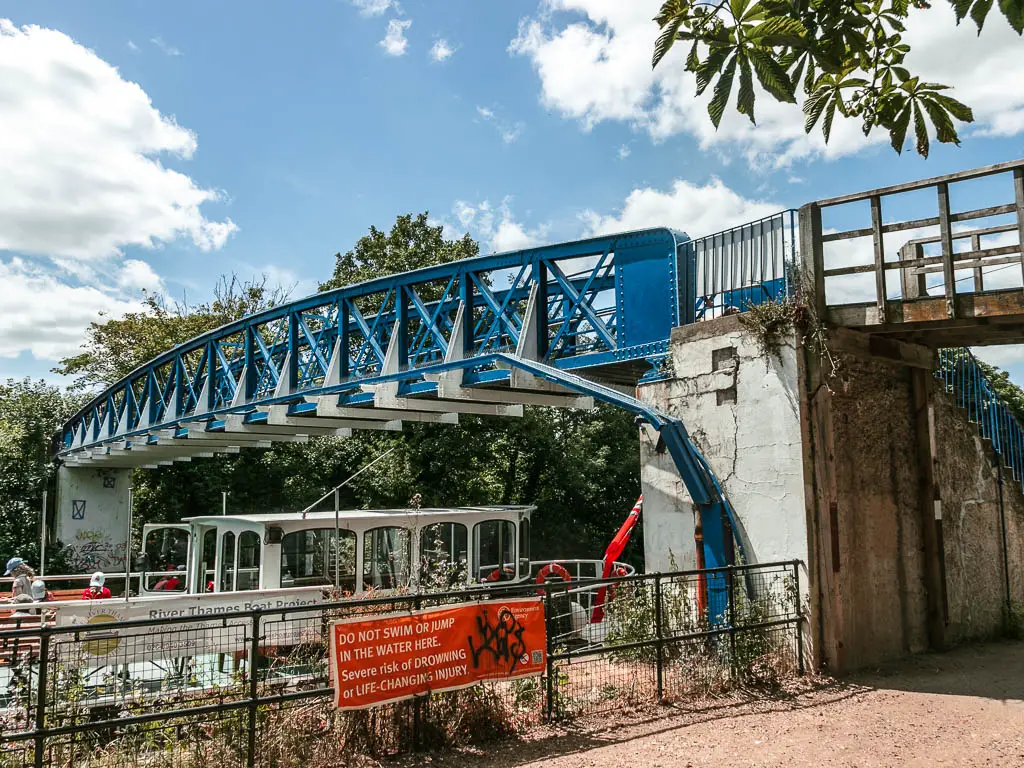 A blue metal bridge over the river.