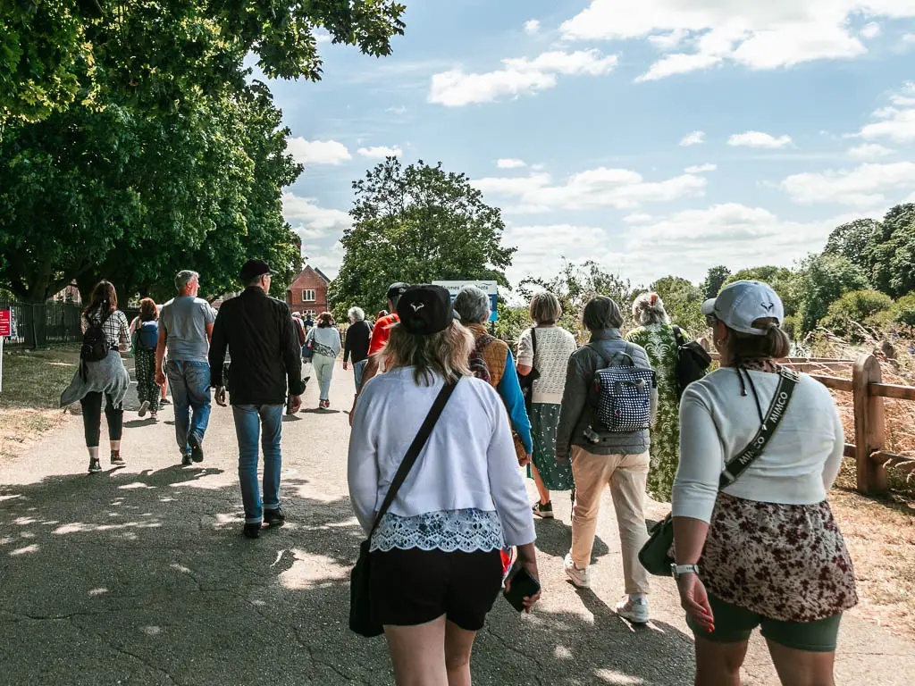 Masses of people walking along the wide path.