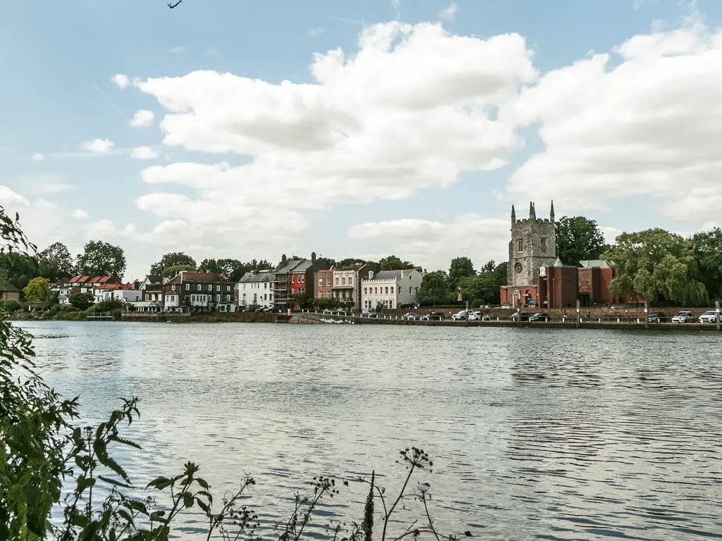 Looking across the rippled with to colourful houses on the other side, halfway through the walk from Hampton Court to Putney.