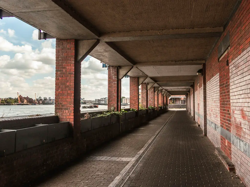 A Sheltered walkway, with river to the left.