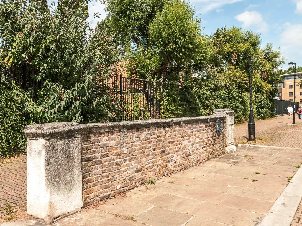 An old wall in the middle of the walking path.