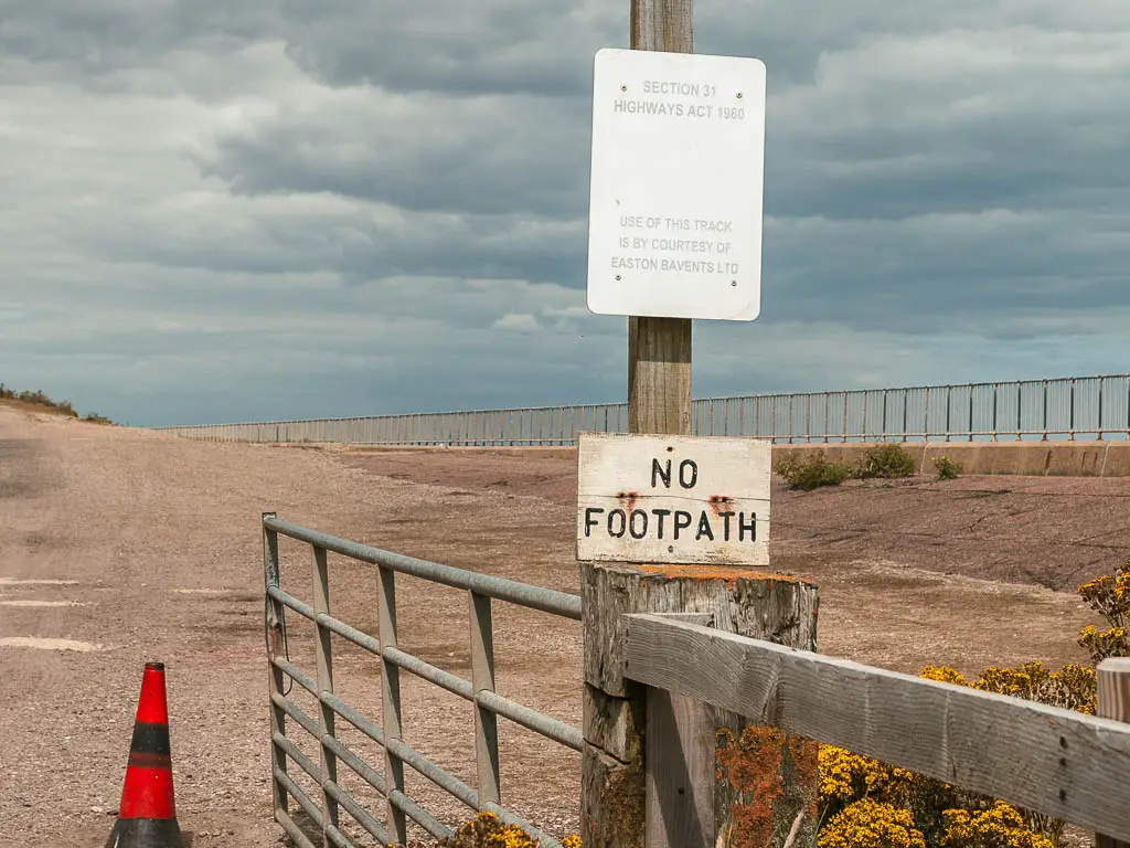 A 'no footpath' sign on a gate.